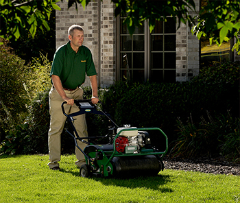 Weed Man technician aerating lawn